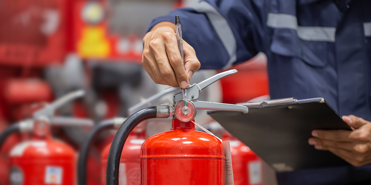 Engineer are checking and inspection a fire extinguishers tank in the fire control room for safety training and fire prevention.